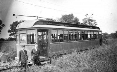 two men standing in front of the train