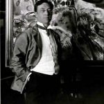 Kandinsky standing before one of his paintings. 1913.