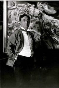 Kandinsky standing before one of his paintings. 1913.